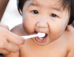 Girl practicing brushing her teeth,A child aged of one year old. Healthy and kid concept.