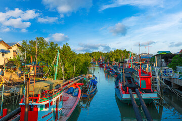 A fishing village with fishing boats moored in Thailand,small fishing boats in asia,Thai fishing boats docked at Samui beach, Thailand in a summy day