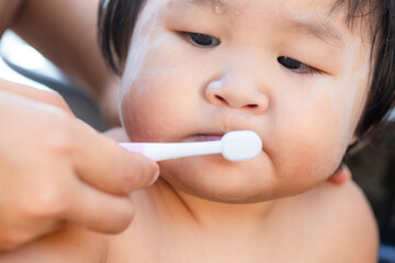 Girl practicing brushing her teeth,A child aged of one year old. Healthy and kid concept.