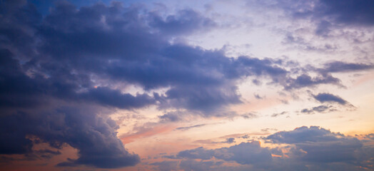 Obraz premium Clouds and orange sky,Real majestic sunrise sunset sky background with gentle colorful clouds without birds.Panorama, large