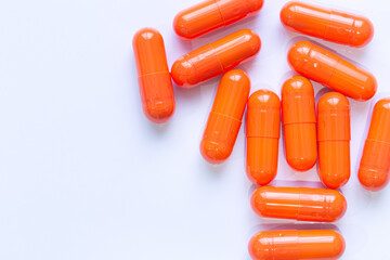 Close-up of orange pill capsules isolated on white background,Organic turmeric capsules isolated on white background