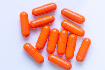Close-up of orange pill capsules isolated on white background,Organic turmeric capsules isolated on white background