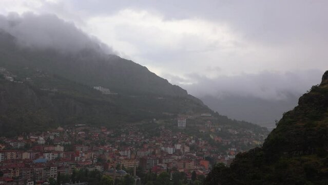 Rainy day in the mountains in Turkey. Rain and fog, mountains and houses, green plants and rain.