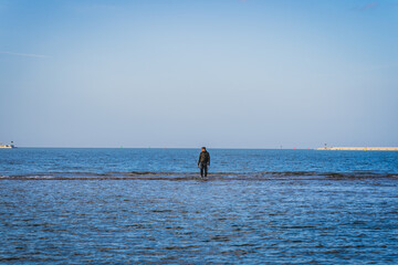 A man standing on the sea.