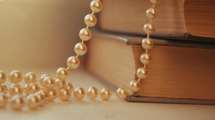 Gift jewelry for women - beautiful golden pearls. Beautiful bright rustic background with golden...