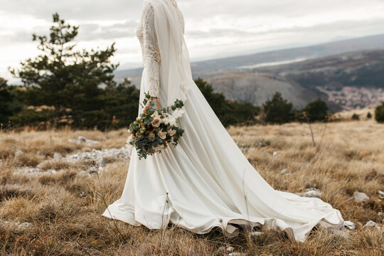 beautiful elegant  bride standing and holding bouqet