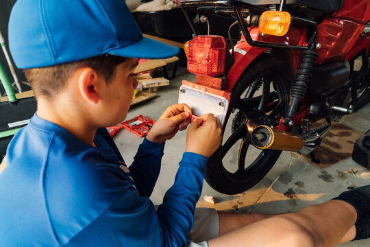 Getting moped ready to drive. 