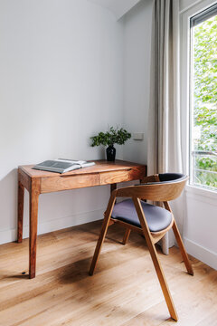 study space with wooden desk and chair, with plenty of natural light