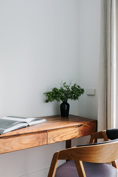 study space with wooden desk and chair, with plenty of natural light