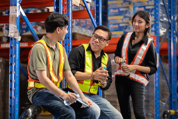Asian warehouse workers rest during factory break time