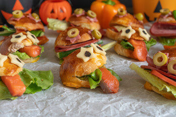 Monster Sandwich made with cheese, salmon and lettuce on textured paper. Kid's food ideas for Halloween.