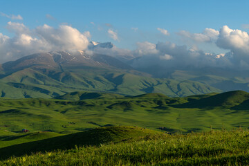 A picturesque plateau against the backdrop of snow-covered peaks in the Trans-Ili Alatau (Kazakhstan)