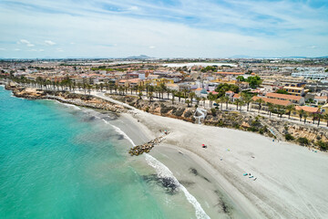 Aerial shot, drone point of view panoramic image of Torre de la Horadada townscape with sandy...