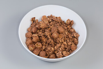 Breakfast cereals of oat flakes and corn balls with cocoa