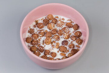 Breakfast cereals of cocoa oat flakes, corn balls with milk