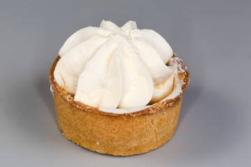 Small fruit tart with custard top on a gray background