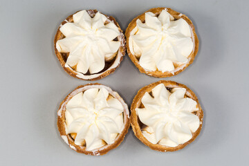 Small tarts with custard top on gray background, top view