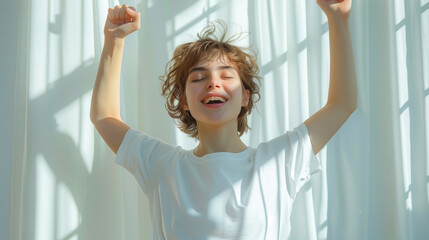 A young woman in love, joyful, happy, enjoying herself, wearing a white T-shirt with her arms raised to the sky