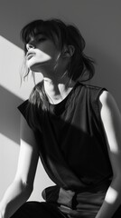 A black and white photo of a woman sitting on a chair © Maria Starus