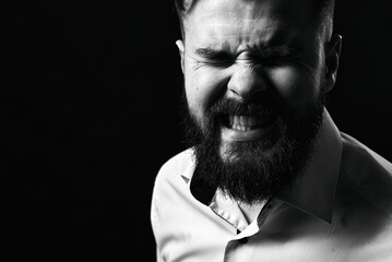 Emotional portrait of a man on a black background. Grain effect used