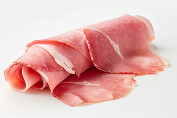 a roll of ham on a white surface