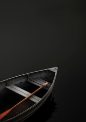 A top view of a vintage wooden rowboat on dark, calm water resembling background, creating a minimalist and serene scene.