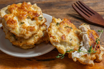 Chicken cutlets or patties for tasty snack on wooden background.
