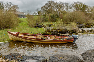 Fishing boat moored at the bottom of a garden