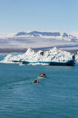 tourist boats on the famous Jökulsárlón lagoon lake. With a stunning glacier and a breathtaking mountain panorama in the background in Jökulsárlón, iceland 