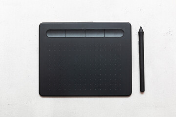 Top view of graphic tablet and pen for illustrators, designers and photographers on light background. 3d rendering