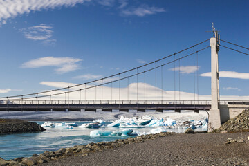 the bridge called white gate bridge over the Jökulsárlón river with glaciers and icebergs underneath