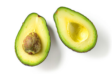 two halves of an avocado on a white surface