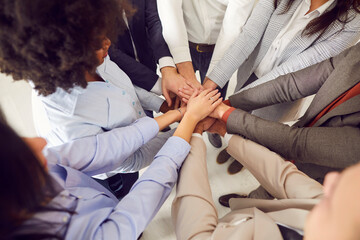 Business wearing suits people putting their arms in a pile. Stack of hands of a group of diverse...