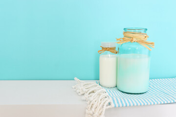 Photo of milk over mint background. Symbols of holiday - Shavuot