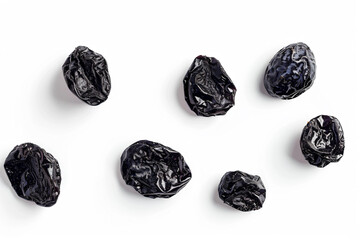 a group of dried plums on a white surface