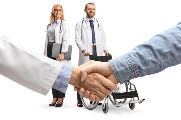 Male and female doctors and a handshake with a patient, trust and health care concept