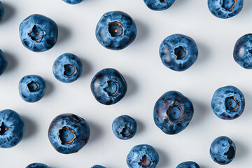 a group of blueberries are on a white surface