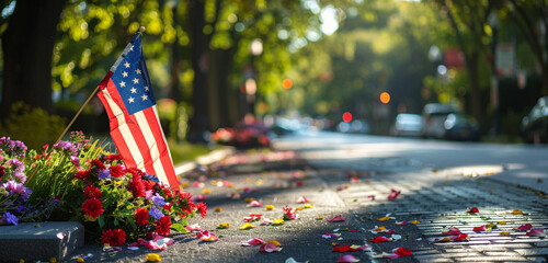 City tribute with a Memorial Day flag and street flowers at a veteran's grave.