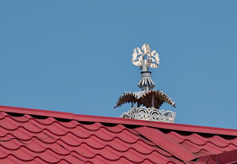 a brick chimney on the roof of a village house.