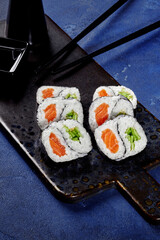 Yin and yang shaped futomaki rolls with salmon and cucumber