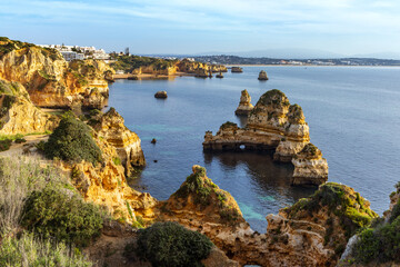Spectacular stacks and cliffs of Praia dos Pinheiros and Praia do Camilo in Lagos, Algarve,...