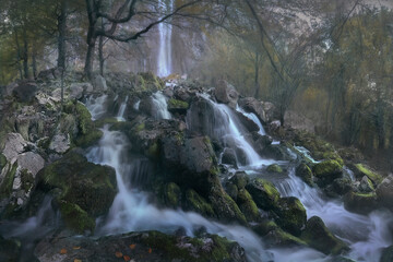Waterfall in the birth of the river Ason, Cantabria, Spain from inside the beech forest