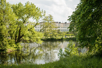 River in park with buildings in background