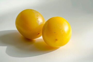 two lemons sitting on a white surface