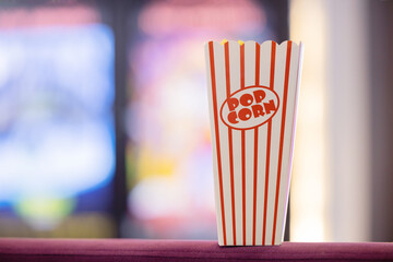 Popcorn bucket with blurred cinema background