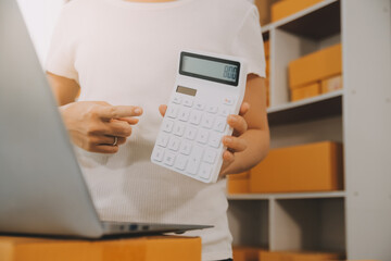 Startup small business entrepreneur SME, asian woman receive order on phone. Success young Asian small business owner home office, online sell marketing delivery, SME e-commerce telemarketing concept