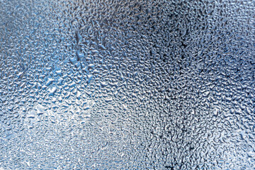 Water drops on the window as an abstract background. Close up.