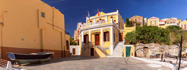 Panoramic view of town square lined with traditional colorful buildings on Symi Island, Greece