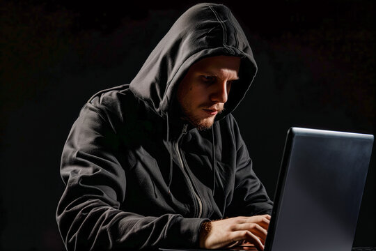 Man in a hoodie using a laptop computer