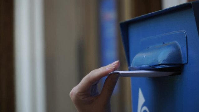 girl sends a letter. woman sends a letter by mailbox